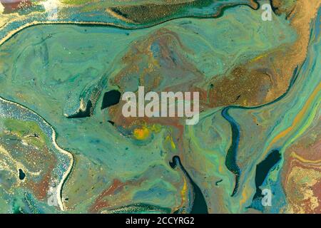 Green and gold marbling liquid background. Fluid art abstract texture. Mixed acrylic inks. Stock Photo