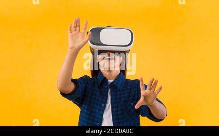 Little girl wearing virtual reality goggles at studio Stock Photo