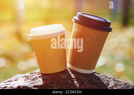 Two cups of coffee in autumn park, close up Stock Photo