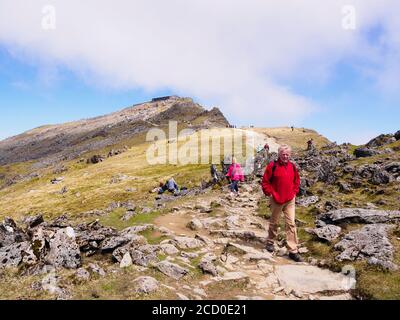 Walkers walking on the Rhyd Ddu path from Mt Snowdon summit and cafe in Snowdonia National Park. Gwynedd, North Wales, UK, Great Britain Stock Photo