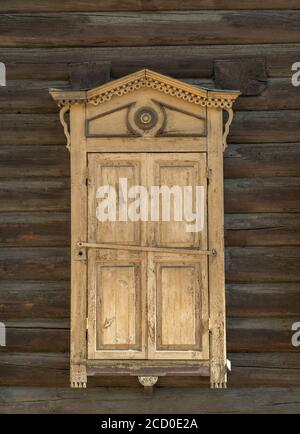 the old wooden window with closed shutters. Stock Photo