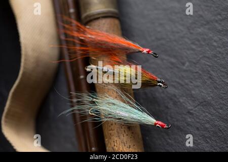 Three salmon flies that were probably homemade on the cork handle of an old  fly fishing rod. From a collection of vintage fishing tackle. Dorset Engla  Stock Photo - Alamy