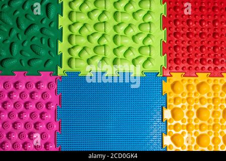 Orthopedic mats view from above. Bright colorful multicolored mats to prevent flat feet and foot massage Stock Photo