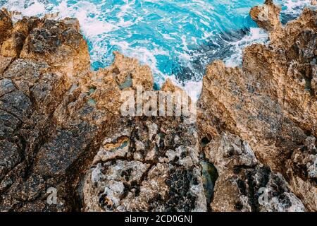 Dangerous rocky sea shore with azure water, aerial drone top view. Stock Photo