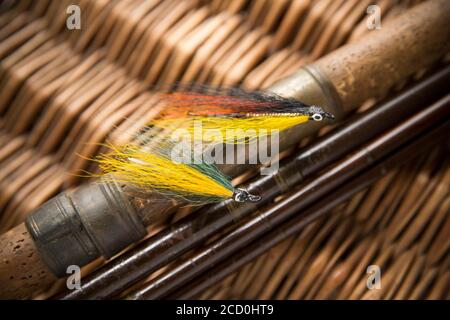 Two salmon flies that were probably homemade on an old wooden salmon fly  fishing rod. From a collection of vintage fishing tackle. Desaturated  colours Stock Photo - Alamy