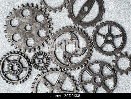 Top closeup view of gear wheels collection on glittering background with blank space for text. Top view, flat lay. Stock Photo