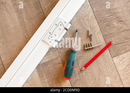 Hinge on the white door frame Stock Photo