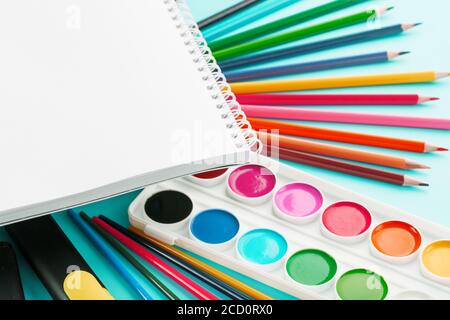 A set of school supplies for learning and creative development on a cyanide background. Stock Photo