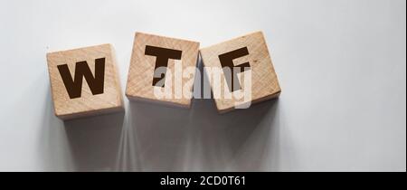 WTF abbreviation on wooden blocks, question concept, top view on grey background Stock Photo