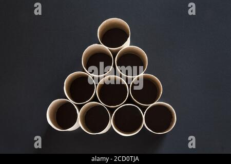 empty toilet roll tubes on black background, no toilet paper - concept of panic buying of toilet rolls as people panic buy essentials items in UK Stock Photo