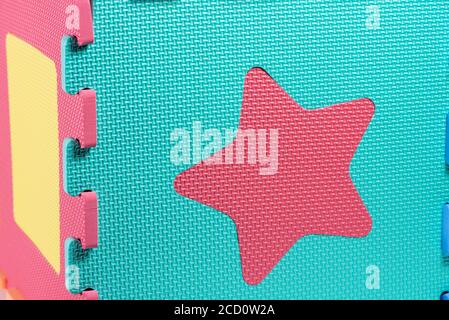 Macro photo of the details of a foam eva. Colored rubber mat puzzle for children. Stock Photo