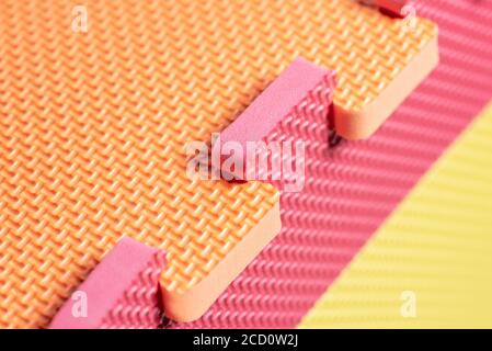 Macro photo of the details of a foam eva. Colored rubber mat puzzle for children. Stock Photo