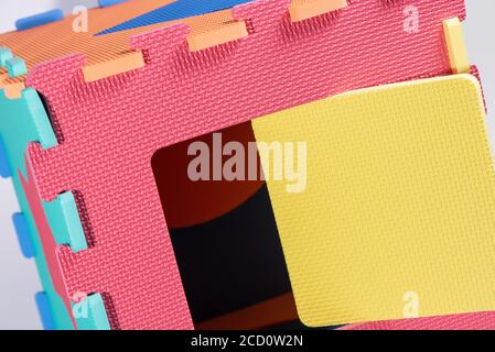 Macro photo of the details of a foam eva. Colored rubber mat puzzle for children. Stock Photo