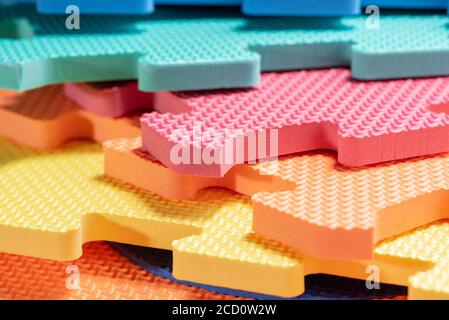 Macro photo of the details of a foam eva. Colored rubber mat puzzle for children. Stock Photo