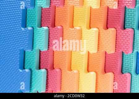 Macro photo of the details of a foam eva. Colored rubber mat puzzle for children. Stock Photo
