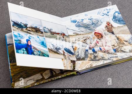 the photobook opened, travel in switzerland, on gray background Stock Photo