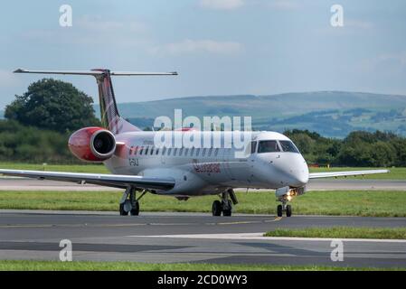 MANCHESTER UK, AUGUST 20 2020: Loganair airlines Embraer ERJ-145EP flight LM535 from the the Isle of Man, UK, is documented taxying on the airport tax Stock Photo