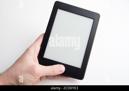 Hand holding blank ebook with empty screen Stock Photo