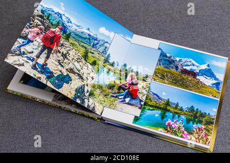 the photobook opened, travel in switzerland, on gray background Stock Photo