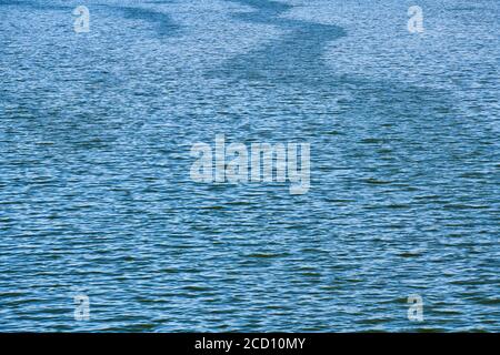 Ocean water texture. Slight flow and light wind on water surface. Blue natural ocean surface background. Wanderlust copy space Stock Photo