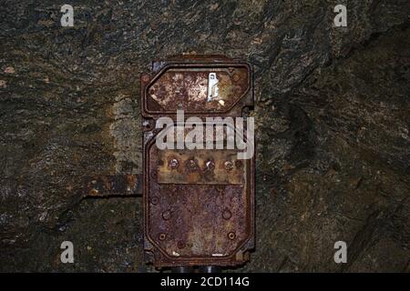 A really old and rusted electric box in an abandoned uranium mine Stock Photo