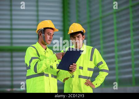 Professional Engineer Portrait Asian engineer wearing hard hat and reflective vest giving thumbs up ...