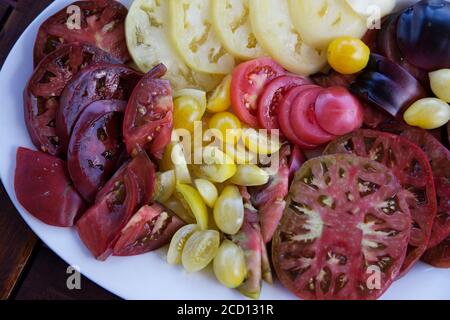 heirloom tomatoes (also called heritage tomato) sliced on the plateau Stock Photo