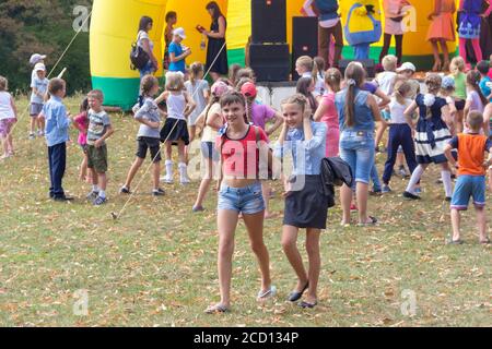 Kamennomostsky, Russia - September 1, 2018: Animators on stage entertain children at the festival day of the village of Kamennomostsky in the autumn p Stock Photo