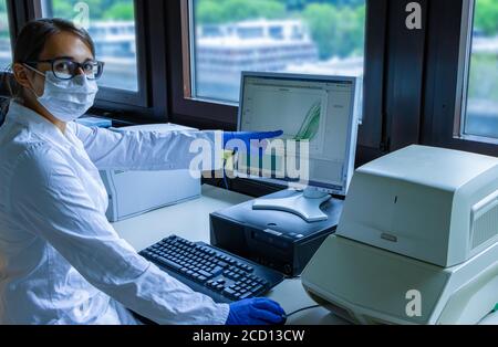 Female scientist explaining corona virus test Stock Photo