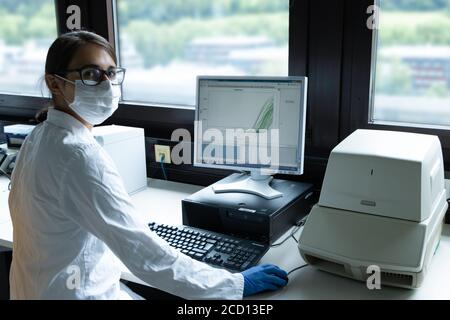 Female scientist conducting corona virus test Stock Photo