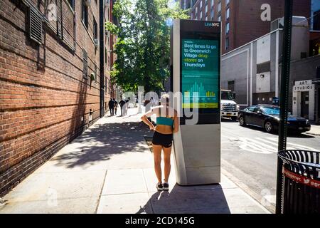 Woman uses a LinkNYC kiosk in Greenwich Village in New York during the COVID-19 pandemic on Thursday, August 20, 2020.  (© Richard B. Levine) Stock Photo