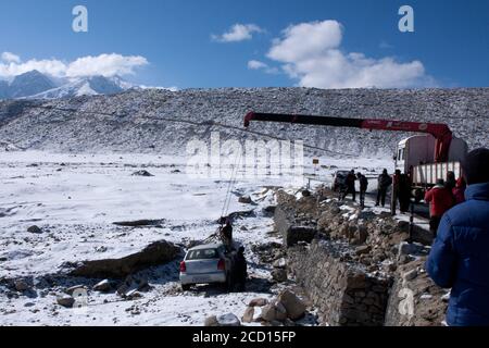 car crash in an accident on the high altitude road on a snowfield in Ladakh in India Stock Photo