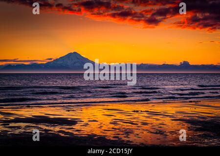 Sunset over Mount Redoubt and Aleutian Range, viewed across Cook Inlet, Kenai Peninsula, South-central Alaska in summertime Stock Photo