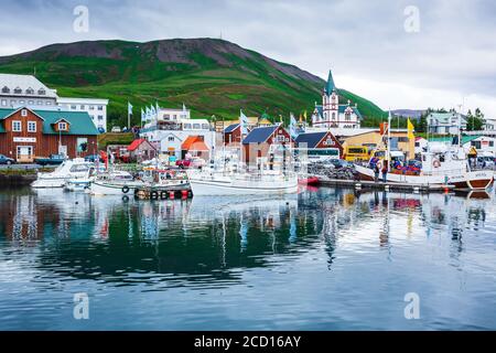 Husavik, Iceland - August 05, 2017: Husavik harbour with traditional houses and fisherman boats. Stock Photo