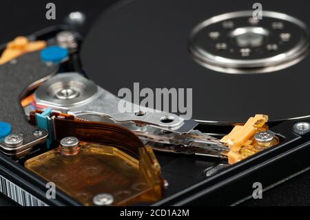 Disassembled laptop hard disk drive, hdd. Close-up. Opened hard drive, magnetic heads and disk plates Stock Photo