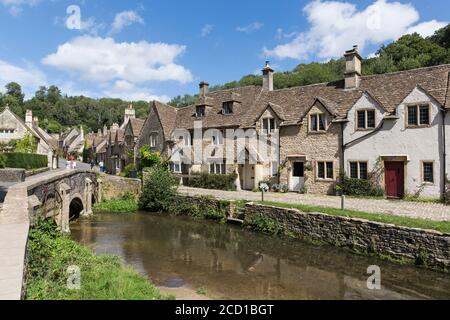Weavers' cottages and old stone bridge over Bybrook River, 'Castle Combe', picturesque Cotswolds village, Wiltshire, England, UK Stock Photo