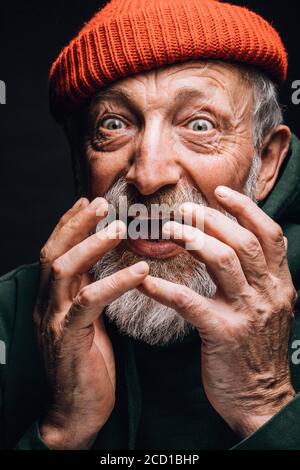 Close up face of old-aged happy retiree with widely open eyes and open mouth feeling amazed or astonished when knew that pension doubled. Isolated on Stock Photo