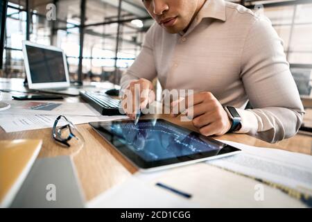 Businessman analyzing stat and dynamic on forex charts at tablet computer Stock Photo