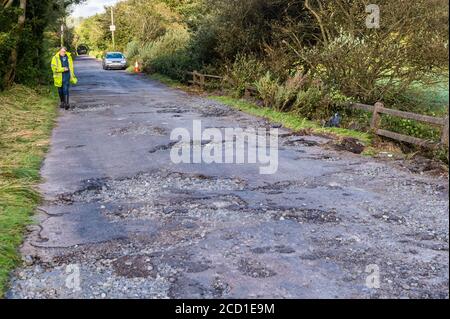 Clonely, West Cork, Ireland. 25th Aug, 2020. The Caheragh to Drimoleague road at Clonely was destroyed during major floods during Storm Francis last night. Cars negotiated the broken road at a crawl this evening. Cork County Council was on scene assessing the damage. Credit: AG News/Alamy Live News Stock Photo