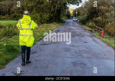 Clonely, West Cork, Ireland. 25th Aug, 2020. The Caheragh to Drimoleague road at Clonely was destroyed during major floods during Storm Francis last night. Cars negotiated the broken road at a crawl this evening. Cork County Council was on scene assessing the damage. Credit: AG News/Alamy Live News Stock Photo