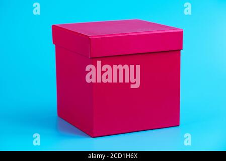 Pink gift box on blue background. Holidays concept. Closeup. Mockup Stock Photo