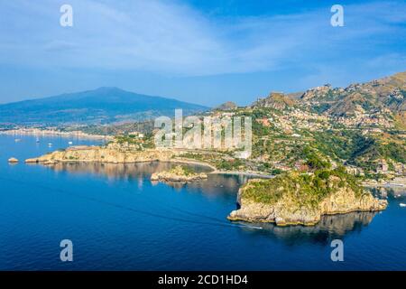 Aerial panoramic view of the town of Taormina, Isola Bella island nature reserve, and Mount Etna on the east coast of Sicily, Italy Stock Photo