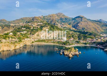 Aerial panoramic view of the town of Taormina and Isola Bella island nature reserve on the east coast of Sicily, Italy Stock Photo