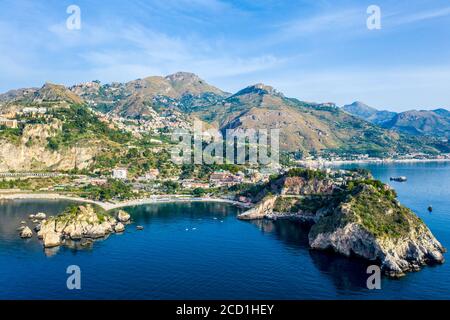 Aerial panoramic view of the town of Taormina and Isola Bella island nature reserve on the east coast of Sicily, Italy Stock Photo