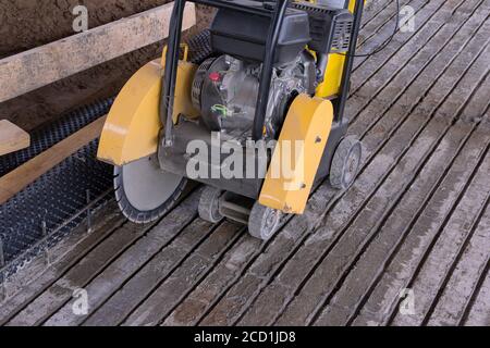 Concrete cutting machine. Equipment for the processing of concrete surfaces. Diamond cutting of materials at the construction site. Stock Photo