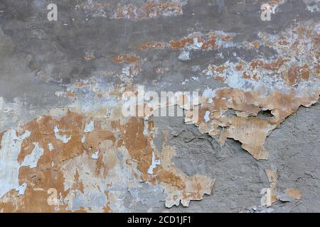 Grunge destroyed concrete wall on an old building. Natural destroyed stone surface. Old shabby cracked stucco. Dirty wall, grunge texture. Painted con Stock Photo