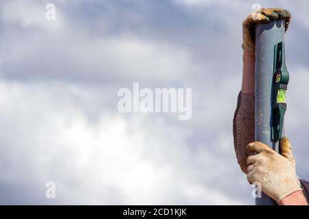 Installation of steel supports using a building level. Construction tool at construction site Stock Photo