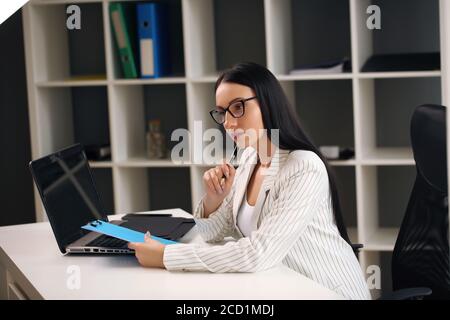 Create something big needs time, woman at the table Stock Photo