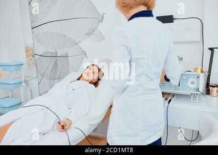 health concept. professional doctor and patient together in hospital room, preparing analyzes. young girl trustingly look at doctor Stock Photo