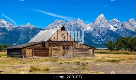 T.A. Moulton Barn at Grand Teton National Park just after sunrise near Jackson, Wyoming. Grand Teton can be seen be seen in the background. Stock Photo